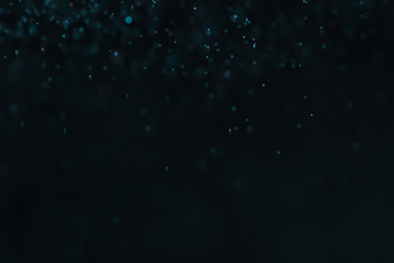 Obraz premium Magic blue bokeh effect on dark background