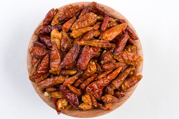 piri piri pepper in wooden bowl isolated on white background.