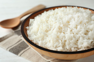 Bowl of boiled rice on table, closeup