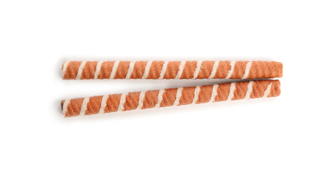 Delicious chocolate wafer rolls on white background, top view. Sweet food