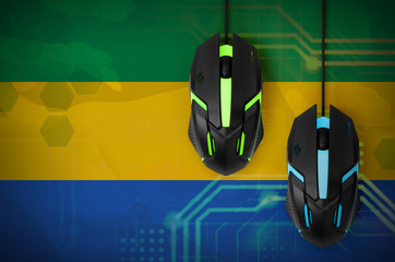 Gabon flag  and two mice with backlight. Online cooperative games. Cyber sport team