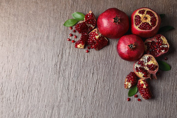 Composition with ripe pomegranates and space for text on color background, top view