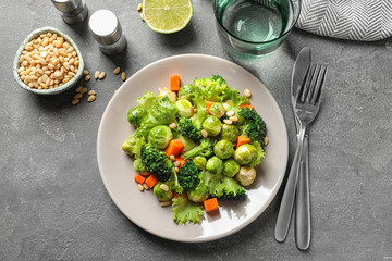 Salad with Brussels sprouts served on grey table, flat lay