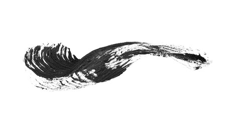 Smear of black mascara for eyelashes on white background