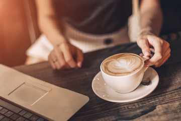 Beautiful woman drinking coffee sitting in a cafe.
