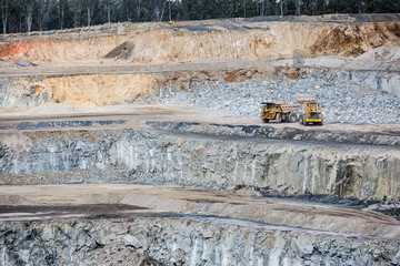 Dumper truck being filled by a bulldozer at a stone quarry in Victoria, Australia © Michael Evans
