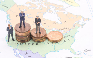 Miniature people, businessman standing on map American