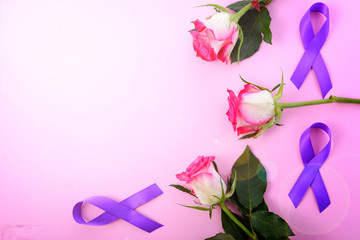 International Women's Day, March 8, flat lay arrangement of roses and purple ribbons on pink wood table background with lens flare.