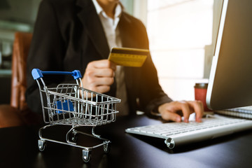 Cart Online Shopping concept. businesswoman hand using smart phone, tablet payments and holding credit card online shopping, omni channel, computer virtual icons 
