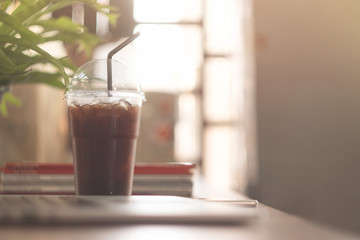 cup of coffee on wooden table with laptop