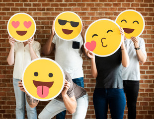 People holding positive emoticons