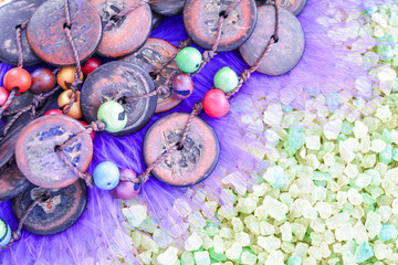 Obraz na płótnie Canvas Colorful Beads from Coconut and Acai Berry on Crystals of Bath Sea Salt for Spa
