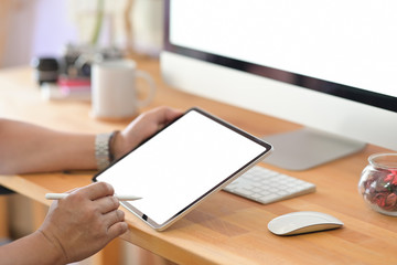 Young man using a tablet in office workspace