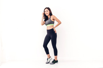 Fototapeta na wymiar Sport woman in sportswear relax stand after workout against copy space for adding text with white wall background.Diet concept.Fitness and healthy lifestyle
