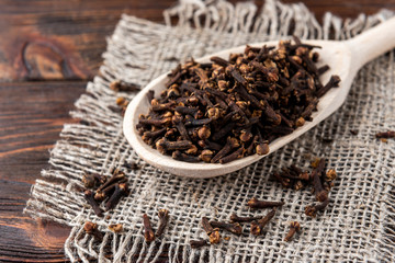 Clove on dark wooden background.