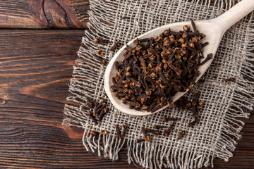 Clove on dark wooden background.