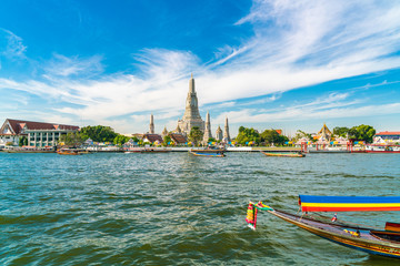Temple of dawn Wat Arun with boat blue sky sunny day