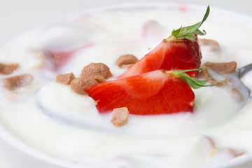 strawberry with yogurt and mint in bowl on wood background