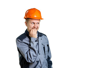 A scared builder worker closes his mouth from fear. Isolated on white background. Construction mistake.