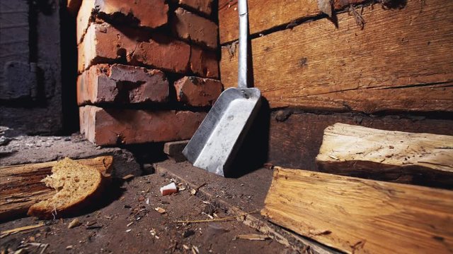 Little gray mouse, that lives under brick stove, is comming out for a slice of bread, eating it and taking into her hide