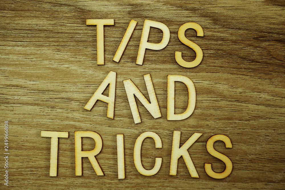 Poster tips and tricks text message on wooden background