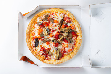Delicious hot pizza in a box with ham.