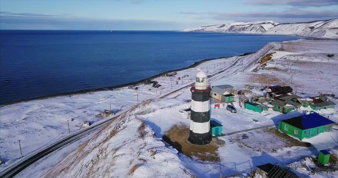 Aerial panoramic view of Lopatino lighthouse and Tatar Strait, sea of Japan, on the background. It's an octagonal tower 17 meters height build in 1912. Sakhalin island, Russia