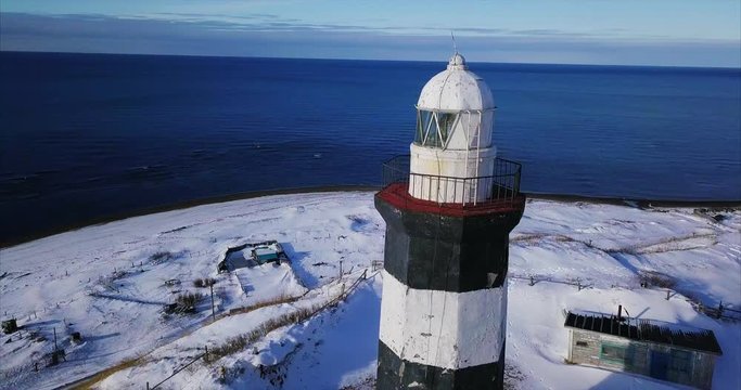 Close aerial panoramic view of Lopatino lighthouse and Tatar Strait, sea of Japan, on the background. It's an octagonal tower 17 meters height build in 1912. Sakhalin island, Russia