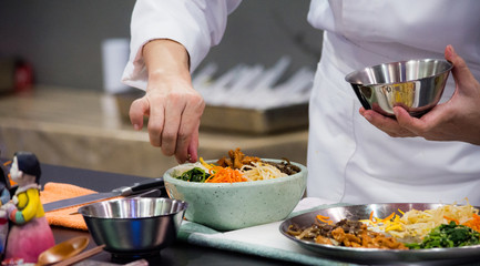Bibimbap, Traditional Korean cusine bibimbap, Chef preparing Korean food, chef cooking in kitchen