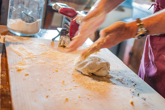 Male hands kneading dough 
