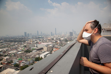 Fototapeta na wymiar Portrait of man wearing facial hygienic mask outdoors. Ecology, air pollution, Environmental awareness and virus protection concept 
