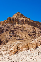 Interesting shapes trails surrounded by caves, rocks, cliffs of ancient cooper mines canyons and mountains range in Timna National Park