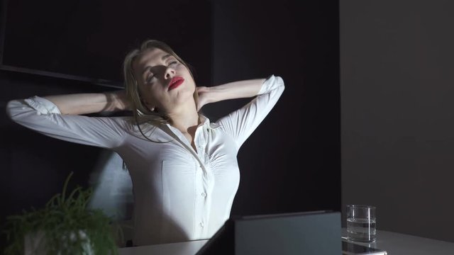 4К. Alone sexy business woman  work at tablet in office and stretch.