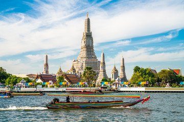Temple of dawn Wat Arun with boat blue sky sunny day
