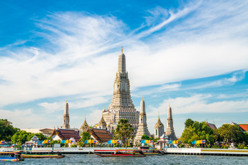 Temple of dawn Wat Arun with boat blue sky sunny day
