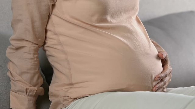 Stressed pregnant woman feeling sharp pain in belly, contractions, prenatal care