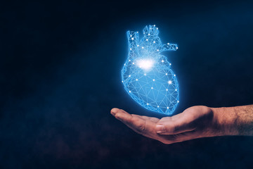 Human hand holding neon blue heart innovative technologies. Mixed media.