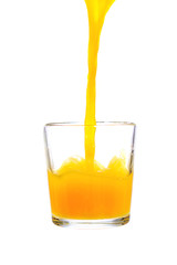 pouring orange juice in glass isolated on white background