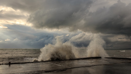 Storm waves over a pier in the Adler, Sochi