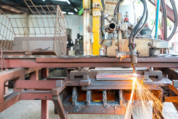 Close up torch or tip and flame with sparkle form oxygen and acetylene of gas cutting machine for industrial at factory