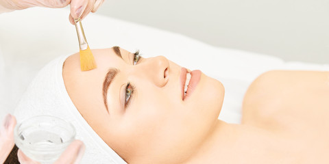 Facial brush peel retinol treatment. Beauty woman peeling procedure. Cosmetology young girl...