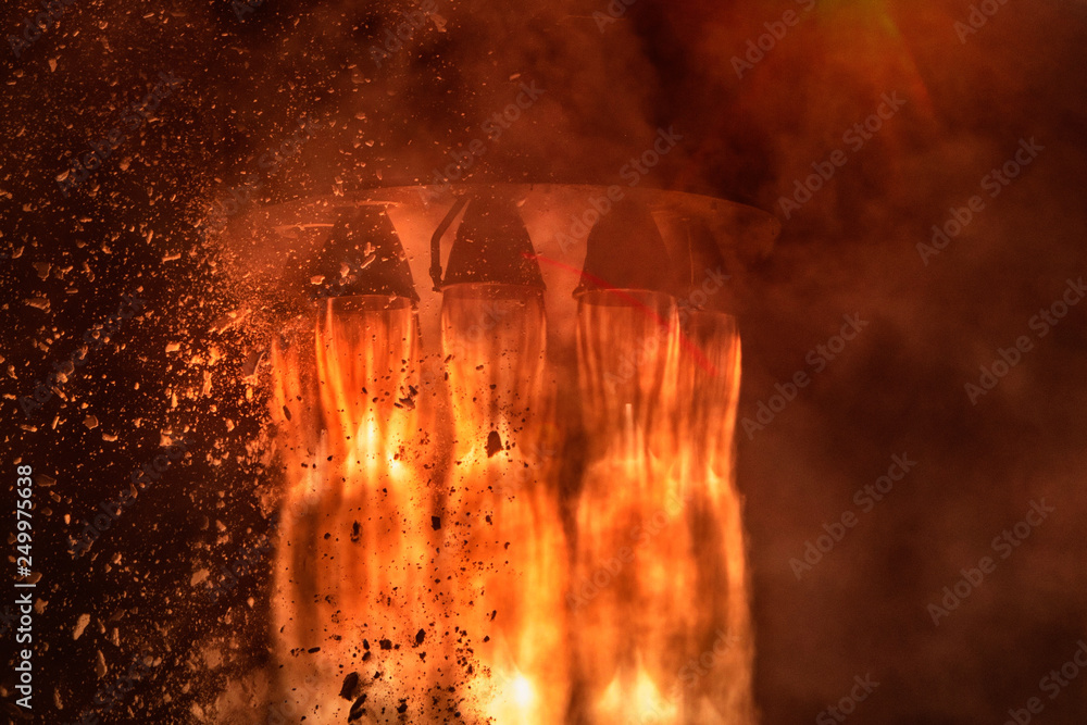 Poster rocket engines and fire duting the missile launch at night, close up conceptual image. elements of t