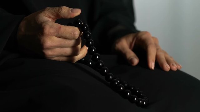 Faithful muslim woman counting prayers by rosary in hand, religious meditation