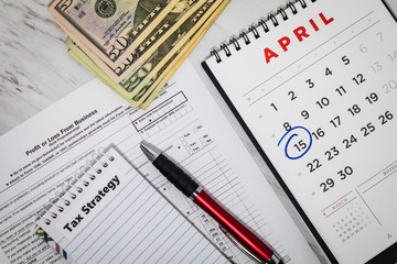 Obraz premium Tax Strategy still life business finance concept with calculator and tax forms, flat lay 