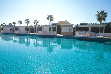 Open air swimming pool blue surface background in hotel