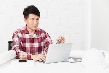 asian architect at construction site office