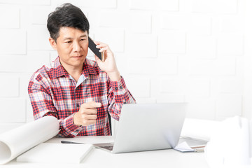 Asian architect at construction site office