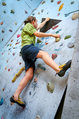 Teenage Boy Training On Climbing Wall