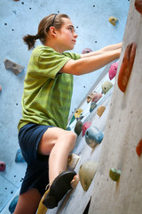 Teenage Boy Training On Climbing Wall