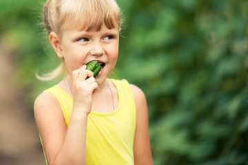 Portrait of a girl eating cucumber